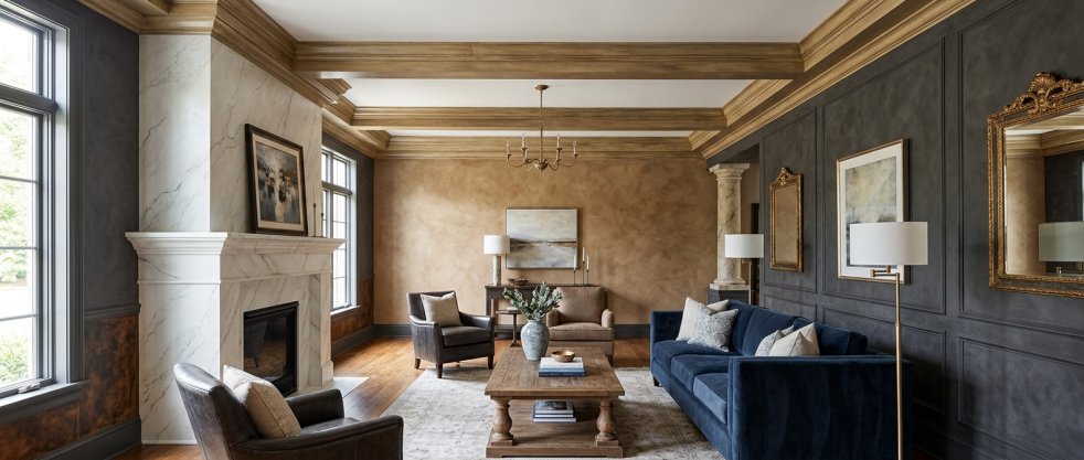 Elegant living room with faux-finish walls, marble fireplace, blue sofa, wood beams and armchairs